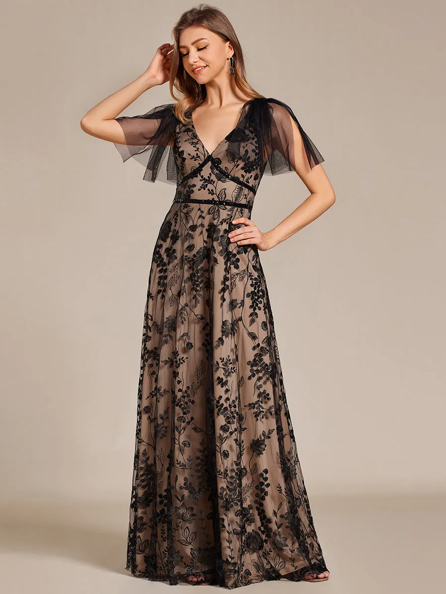 Robe longue de soirée en maille brodée à manches évasées